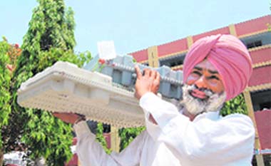 A presiding officer goes to the polling booth after collecting an EVM in Amritsar 