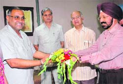 Justice RS Mongia (retd), chairperson, PSHRC, welcomes Avinash Rai Khanna (left) in Sector 34, Chandigarh,