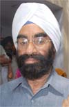 Joginder Singh, son of late President Giani Zail Singh, shows his finger marked with ink after casting the vote at village Sidhwan in Faridko