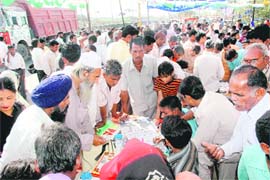Voters swarm polling agents to check their names in the voters’ list at a polling booth in Chandigarh