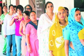 Residents of Sector 10 await their turn outside the polling station in Sector 10