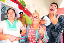 A family comes out of the polling station after casting their ballot in Sector 10