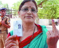 A woman flashes her inked finger after voting at polling station-13 during repoll in Kasturba Nagar on Wednesday.