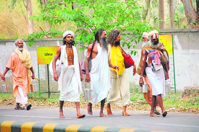 A group of sadhus travel on foot to Rishikesh as public transport remained off the road on polling day in Dehradun. 