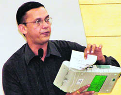An official demonstrates the functioning of an EVM during a rehearsal for counting of votes in Gurgaon on Wednesday.
