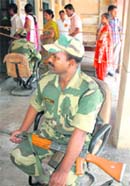 A BSF jawan keeps vigil at a polling booth in Anandpur Sahib