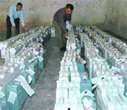 officials examine the EVMs at the Niranjanpur Mandi Complex.