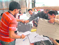 Polling officials from Tehri Garhwal constituency deposit their EVMs at the Niranjanpur counting centre in Dehradun on Thursday