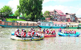 Players in action during a rafting championship on the banks of the Jhelum organised by the Directorate of Tourism Kashmir in Srinagar on Thursday.