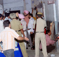 District Electoral Officer Ajeet Singh Pannu and other officials supervise resealing of the strongroom meant for storing EVMs at Government Model Senior Secondary School, Ladowali Road, Jalandhar, on Thursday.