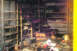 The liquor shop that was set on fire by some miscreants in Pehowa Chowk in Kaithal on Friday.
