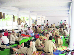 Policemen relax on the premises of the Government College for Women in Fatehabad on Friday on the eve of the counting of votes.