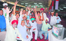Congress workers flash victory sign after the news of Manish Tewari’s victory in Ludhiana on Saturday.