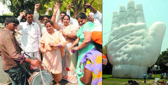 (Left) Congress supporters celebrate outside Sonia Gandhis residence. A hand shaped balloon at the AICC headquarters in New Delhi on Sunday. 