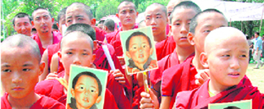 Tibetans hold a protest on the 14th anniversary of disappearance of the Panchen Lama from Tibet, in Dehradun on Sunday.