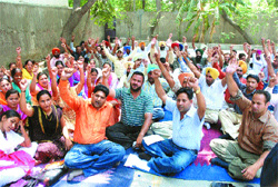 Members of the Multipurpose Health Workers Union stage a dharna at Desh Bhagat Yadgaar Hall in Jalandhar on Sunday.