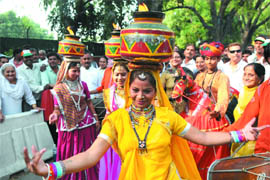 Folk artistes dance outside Congress president Sonia Gandhis residence at 10 Janpath in New Delhi on Monday to celebrate the partys victory in the Lok Sabha elections across the country.