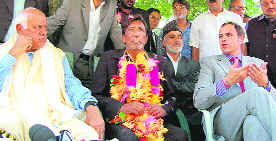 NC chief Farooq Abdullah and Chief Minister Omar Abdullah with Ladakh MP Ghulam Hassan Khan (garlanded), who joined the NC in Srinagar on Monday.