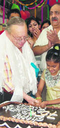 Ruskin Bond cuts a cake on his  75th birthday at Mussoorie on Tuesday. 