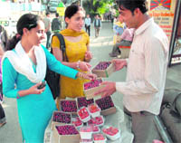 Two girls buy cherry in Shimla.