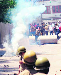 Protesters stone security personnel in Srinagar on Tuesday.