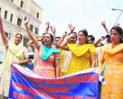 Members of the All J&K Home Guards Welfare Association protest in support of their pending demands at the Mubarak Mandi Complex in Jammu on Tuesday. 