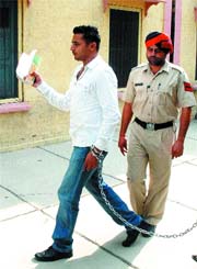 23-year-old Inderjit Singh comes out of an examination centre after appearing for MA-I exam at DAV College 