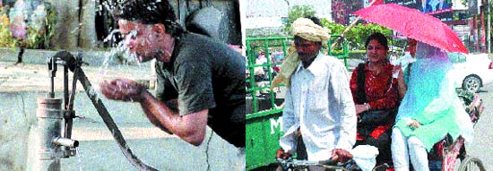 aA man splashes water on his face to beat the heat and an umbrella provides some respite from the heat to two rickshaw passengers in Jalandhar.