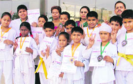 Students of Spring Dale Senior Secondary Public School exult after winning medals in a kickboxing championship in Ludhiana.