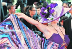 Cannes-09 got its heady moment, as this celebrity flaunted her silver and purple flower embellished hat on the red carpet