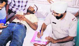 The police records the statement of an injured youth in Bathinda on Tuesday.