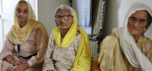 Elderly women abandoned by family members sit in the old age home in Badal village.
