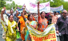 Parents of schoolchildren protest against the hike in fees by private schools at Rajghat in New Delhi on Thursday.
