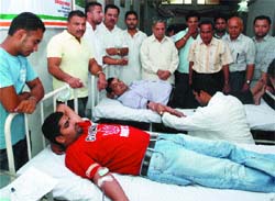 Valunteers donate blood at District Congress Bhavan in Jalandhar on Thursday