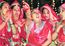 Students perform during the inauguration of a swimming pool at Sat Paul Miittal School in Ludhiana.