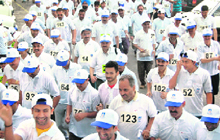 Employees of the Satluj Jal Vidyut Nigam participate in a marathon in Shimla on Sunday.