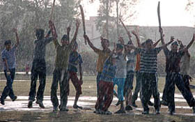 Children enjoy in the rain at Burlton Park in Jalandhar on Sunday.