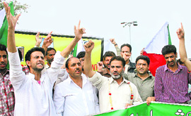 JKLF members shout pro-freedom slogans at the martyrs graveyard in Srinagar on Sunday.