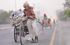 A rehriwala has a tough time as a duststorm hits Bathinda on Sunday evening.