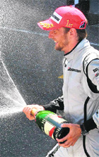 Jenson Button celebrates his win at the Monaco GP on Sunday.