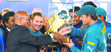 South African President Jacob Zuma (L) gives the 2009 DLF IPL trophy to Deccan Chargers captain Adam Gilchrist.