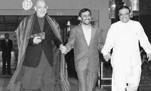 (From left) Afghanistan President Hamid Karzai and his counterparts from Iran and Pakistan, Mahmoud Ahmadinejad and Asif Ali Zardari, join hands as they arrive to attend a summit in Tehran, Iran, on Sunday.