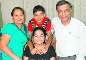 Sanya Gupta, who stood fourth, flanked by their respective family members in Chandigarh on Monday.