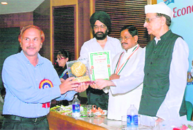 Former Governer Bhishma Naryana Singh gives away the Rashtriya Gaurav Award to Prof C.S. Pundir in New Delhi.