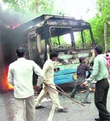 Protesters burn a bus near Ambala on Monday following the attack on a gurdwara in Vienna.