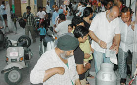 People flock to shops to purchase essential commodities during the one-hour relaxation in curfew in Jalandhar on Monday.
