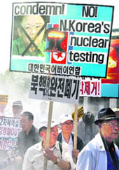 Anti-North Korea protesters hold signs denouncing North Koreas nuclear test, in Seoul on Monday.