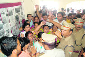 Women activists gherao police officials in Dehradun on Tuesday.