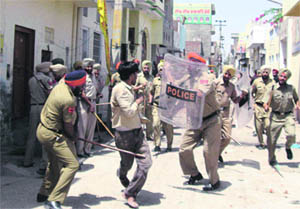 Policemen overpower a protester in Malout on Tuesday