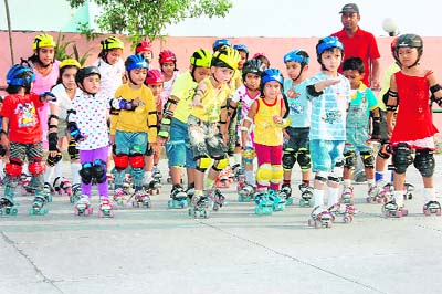 Children learn roller skating at a summer camp in Dehradun.